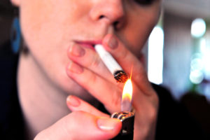 Concept photo of a woman smoking a cigarette.